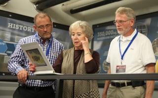 Derek Peterson and Alan Kinder learn more about the MBS warehouse's capacity and capabilities from Nancy Scott.