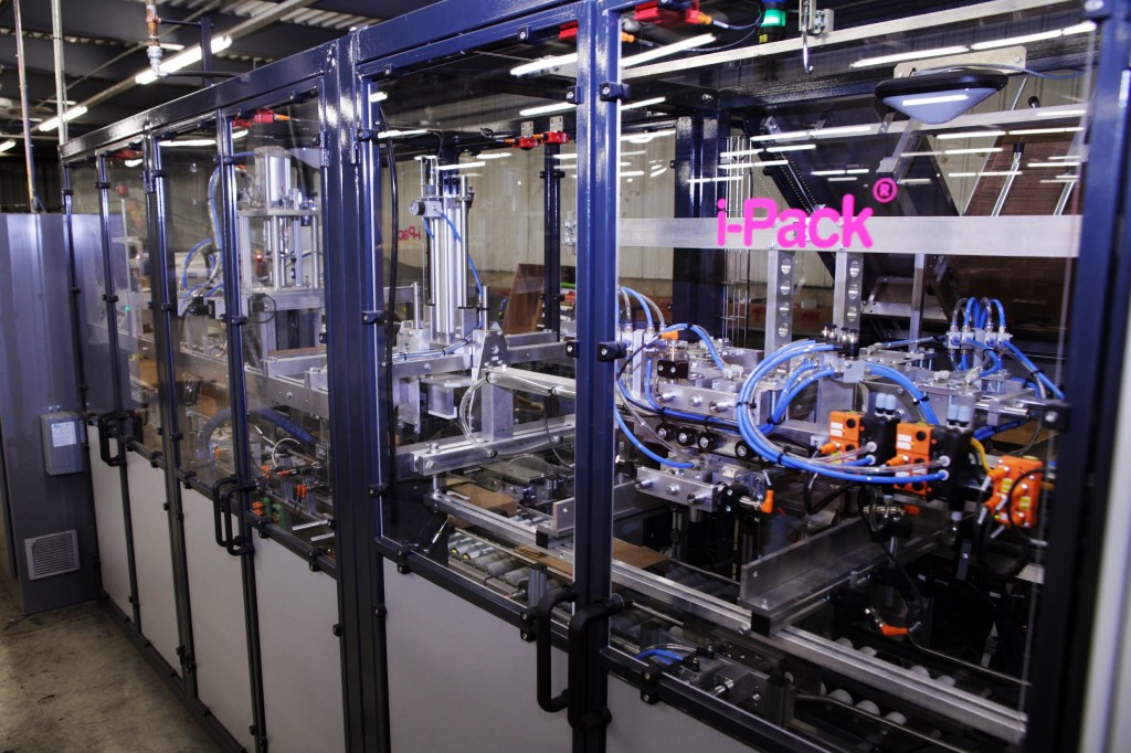 In a process that took more than a dozen workers twice as long, the i-Pack machine boxes our single-order titles automatically.