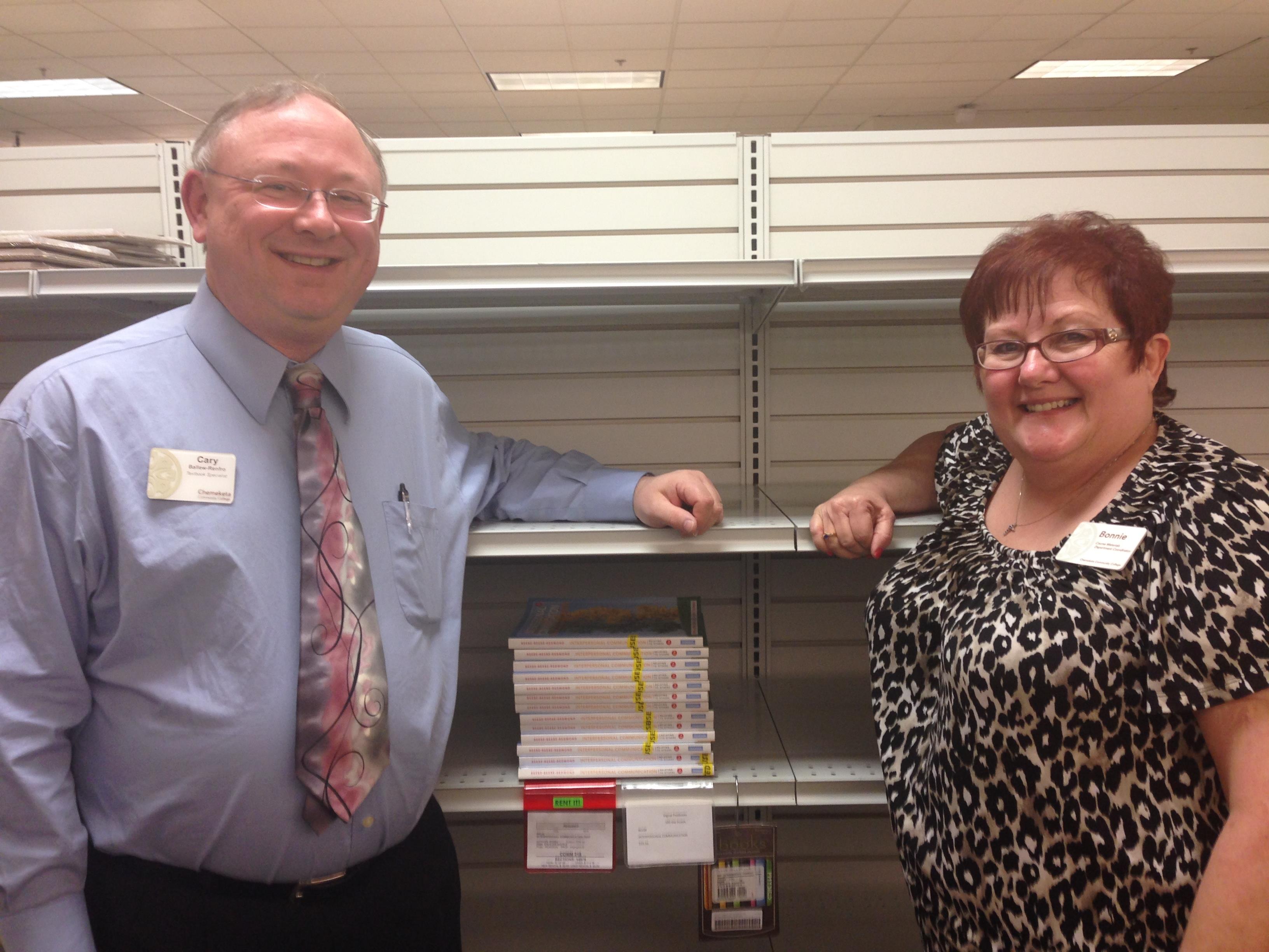 Cary Ballew-Renfro, Textbook Assistant, (left) and Bonnie Perry, Textbook Coordinator, show off the shelf talkers they credit with increasing ebook and rental sales.
