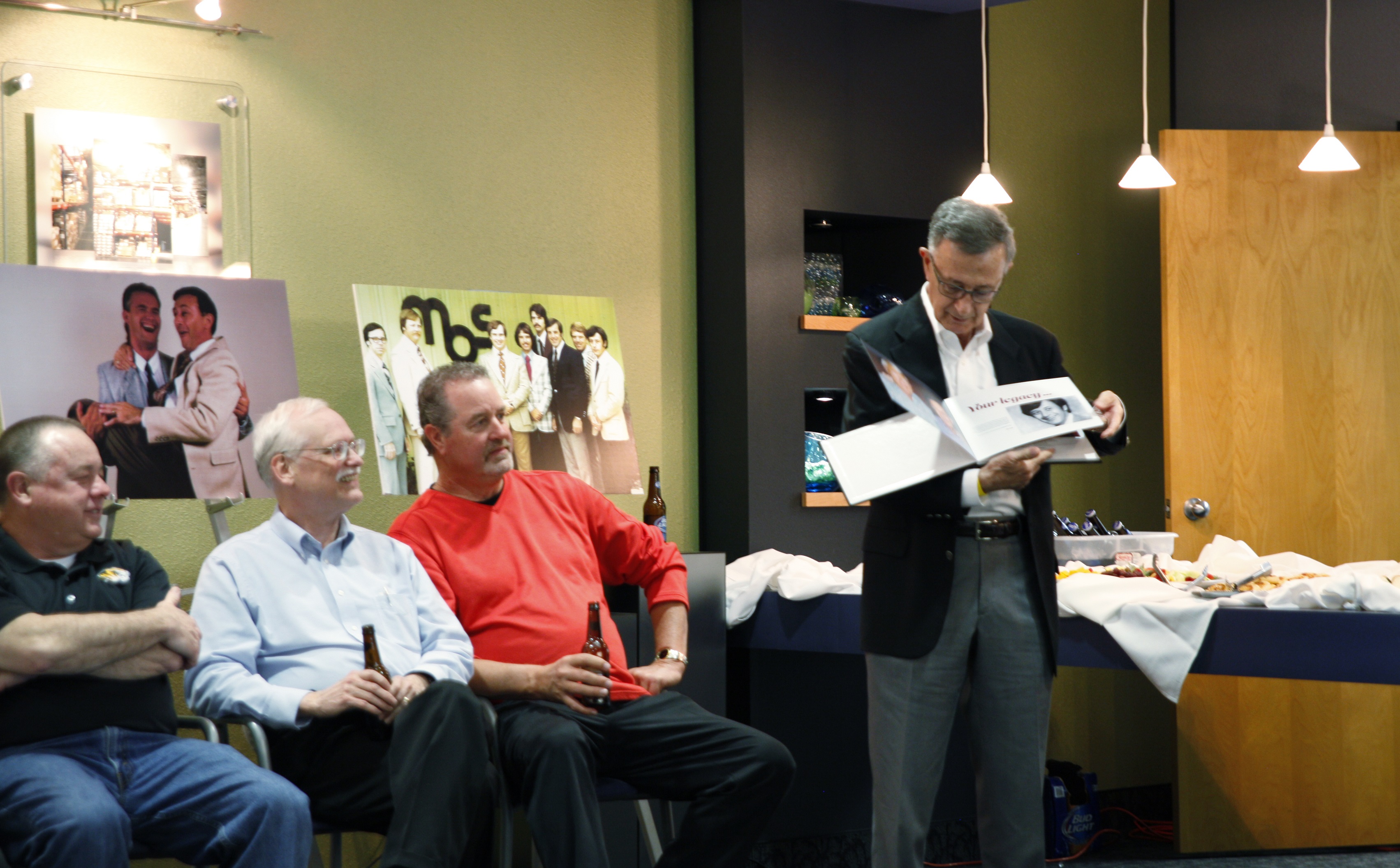 Steve Schwarz flips through a photo album presented to him at his retirement reception March 16. After 37 years with MBS, Schwarz retired in January.